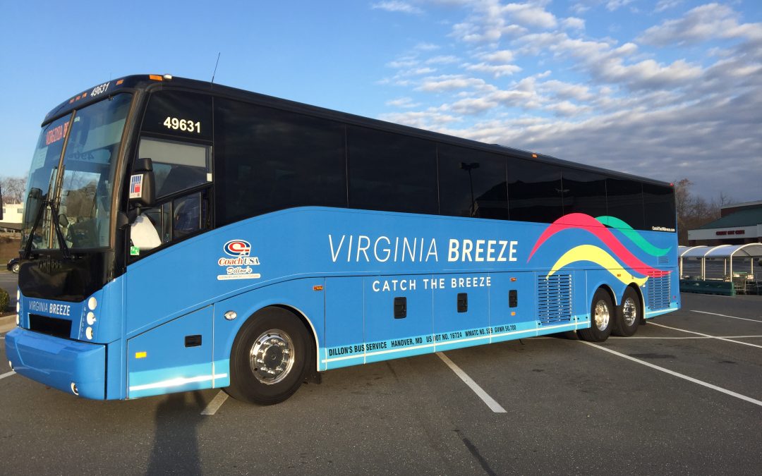 A wide angle view of a blue Virginia Breeze bus.